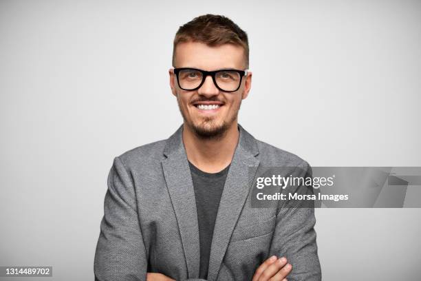 smiling hispanic businessman against gray background - grå blazer bildbanksfoton och bilder