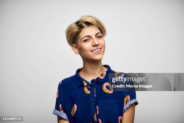 smiling hispanic female against white background - young women white background stock pictures, royalty-free photos & images