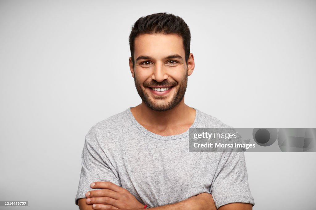 Smiling Hispanic Man Against White Background
