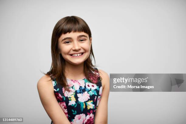 smiling girl against gray background - childs pose stockfoto's en -beelden