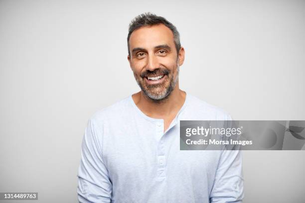 happy hispanic man against gray background - man white background photos et images de collection