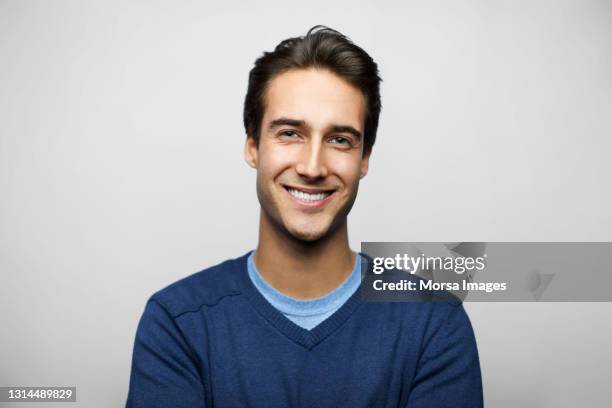 smiling latin american man against gray background - latin beauty stockfoto's en -beelden