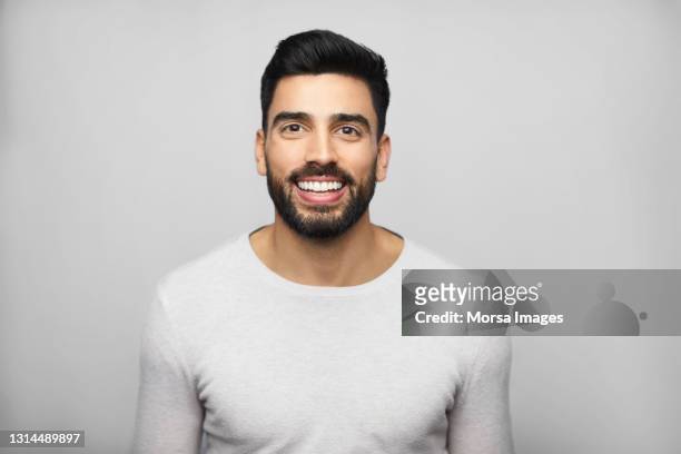 handsome latin american man against white background - südamerikanisch stock-fotos und bilder