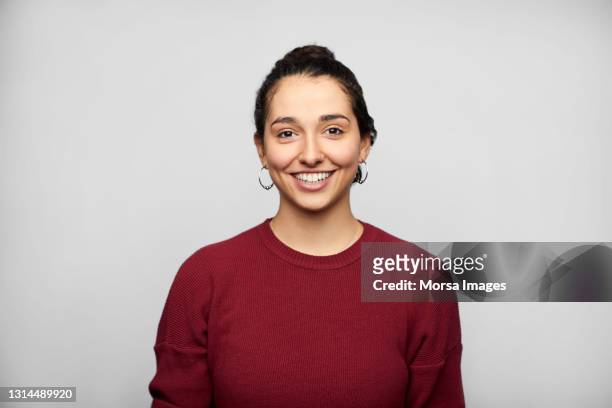 smiling latin american woman against white background - formal portrait stock pictures, royalty-free photos & images