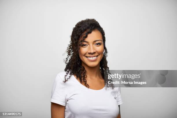 happy hispanic female against gray background - real people foto e immagini stock