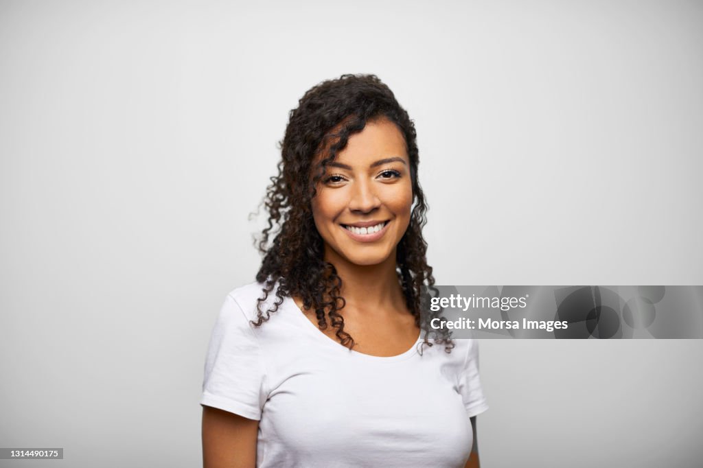 Happy Hispanic Female Against Gray Background