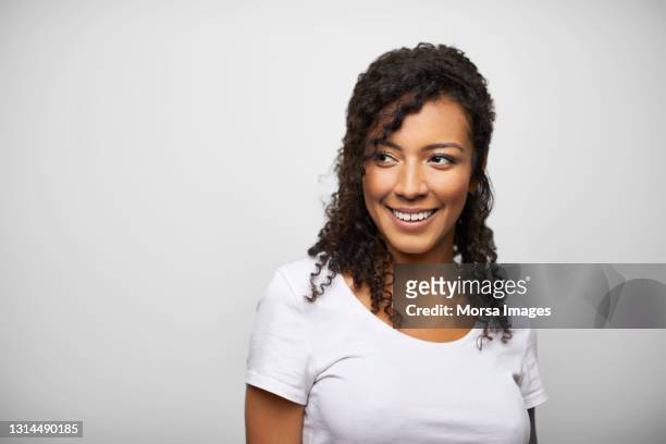 happy latin american woman against white background - looking away stock pictures, royalty-free photos & images