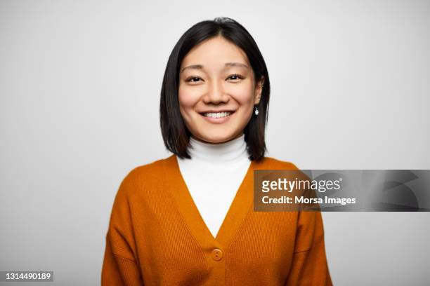 confident hispanic businesswoman against white background - fashion orange colour stock pictures, royalty-free photos & images