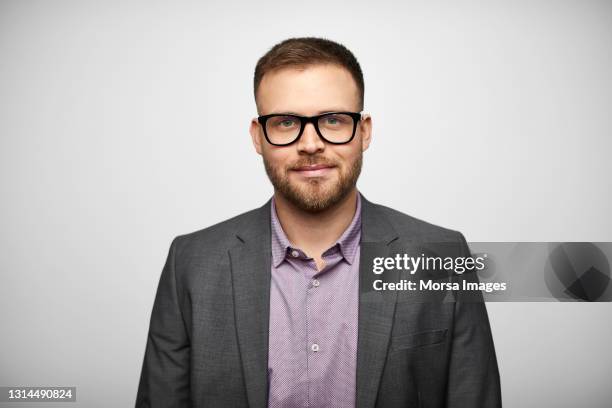 confident hispanic businessman against gray background - man expressive background glasses stock pictures, royalty-free photos & images