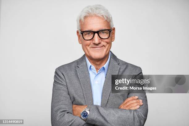 confident hispanic businessman against gray background - grey shirt ストックフォトと画像