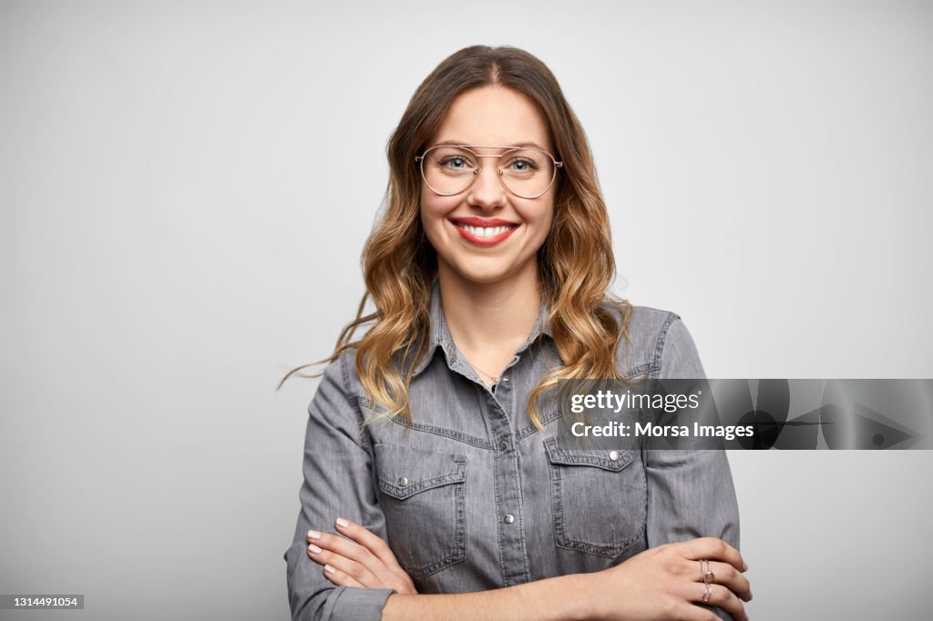 Beautiful Woman With Arms Crossed Against White Background