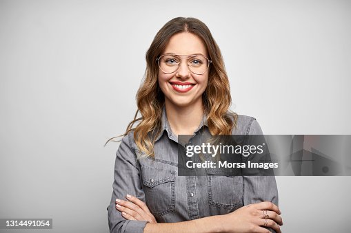 Beautiful Woman With Arms Crossed Against White Background Beautiful Woman With Arms Crossed Against White Background