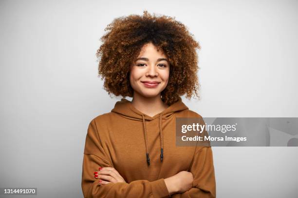 confident young woman against white background - beautiful black women pics fotografías e imágenes de stock