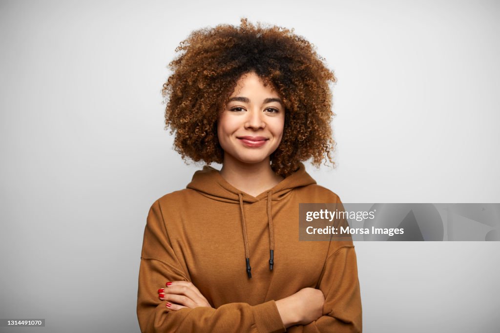 Confident Young Woman Against White Background