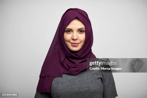 beautiful woman in hijab against white background - veiled woman stock pictures, royalty-free photos & images