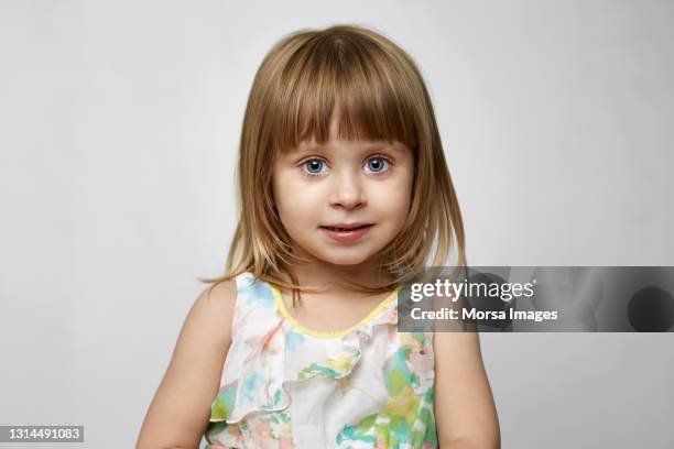 cute girl against white background - female blonde blue eyes stock-fotos und bilder