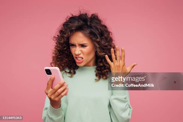 beautiful emotional woman holding smart phone - shouting phone stock pictures, royalty-free photos & images
