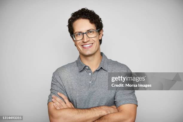 smiling young man against white background - young gray stock pictures, royalty-free photos & images