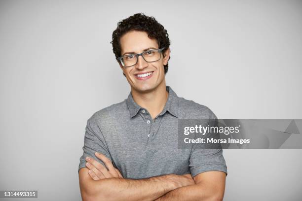 smiling young man against white background - 2020 eyeglasses stock pictures, royalty-free photos & images