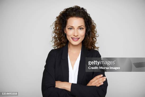 confident female entrepreneur against white background - mid length hair stock pictures, royalty-free photos & images
