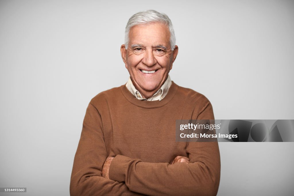 Smiling Elderly Male Against White Background