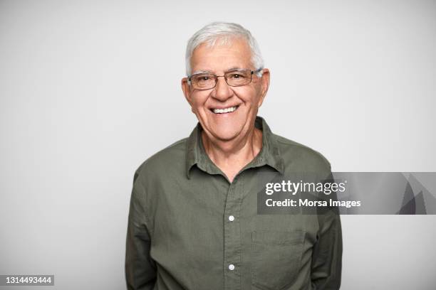 happy senior man against white background - senior studio portrait stock-fotos und bilder