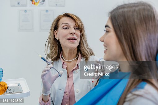 Dentist explains to the patient the dental treatment procedure