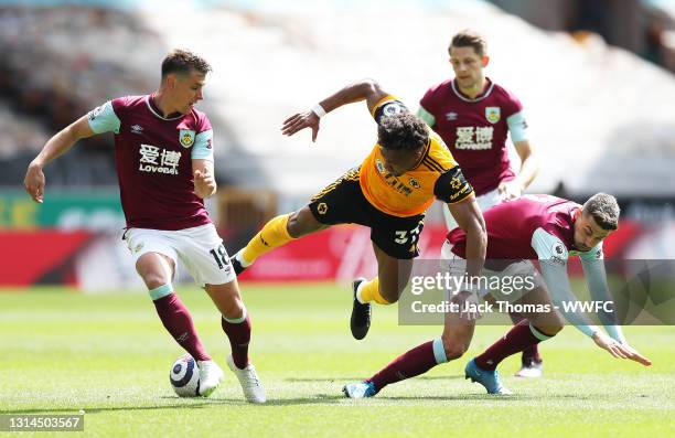 Adama Traore of Wolverhampton Wanderers is challenged by Matthew Lowton and Ashley Westwood of Burnley during the Premier League match between...