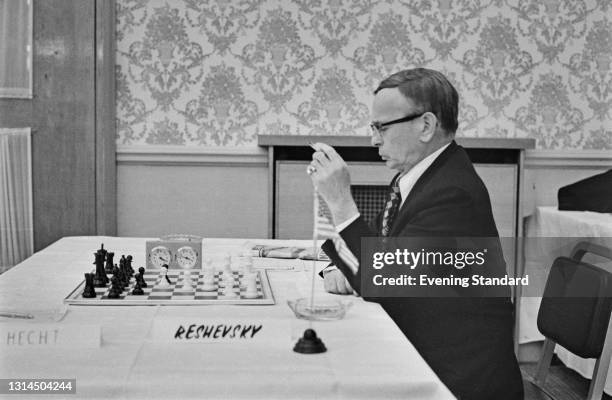 Polish-born American chess player and International Grandmaster Samuel Reshevsky plays Hans-Joachim Hecht of Germany in the Guardian Royal Exchange...