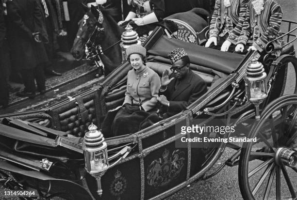 Mobutu Sese Seko , the President of Zaire, in a carriage with Queen Elizabeth II during an official visit to London, UK, 11th December 1973.