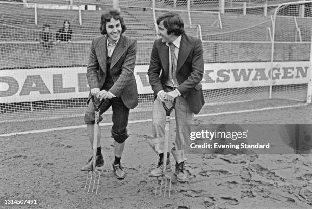 English footballers Gerry Francis and Terry Venables of Queens Park Rangers digging on the pitch at Loftus Road in London, after the third round FA...