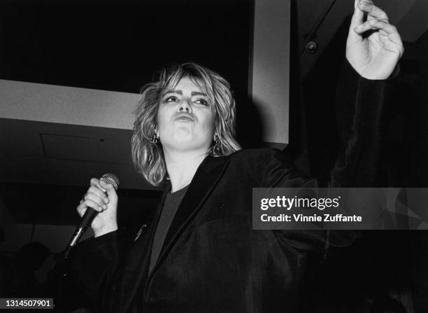 British singer Kim Wilde, dressed in black with a microphone in her right hand, performs in concert at Private Eyes, a nightclub in New York City,...