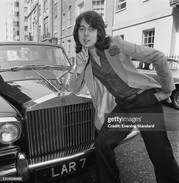 British singer and musician Paul Da Vinci posing with a Rolls Royce, UK, 15th May 1974. He performed the lead vocals for the song 'Sugar Baby Love'...
