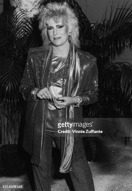 British singer Dusty Springfield wearing a sequin suit over a silk top, with a matching silk scarf, attending an unspecified event in New York City,...