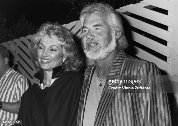 American actress Marianne Gordon and her husband, American singer-songwriter and musician Kenny Rogers , who wears a striped sports jacket, attend an...