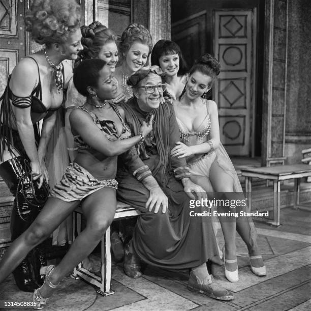 American actor and comedian Phil Silvers poses with a group of female co-stars from the stage comedy 'A Funny Thing Happened on the Way to the...