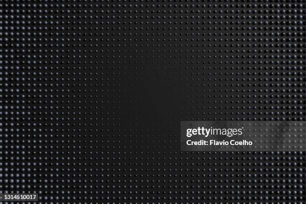 dark hemispheres on black flat surface pattern background - mesh texture stock-fotos und bilder