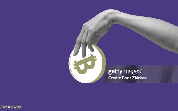 hand holding bitcoin - cryptocurrencies stock-fotos und bilder