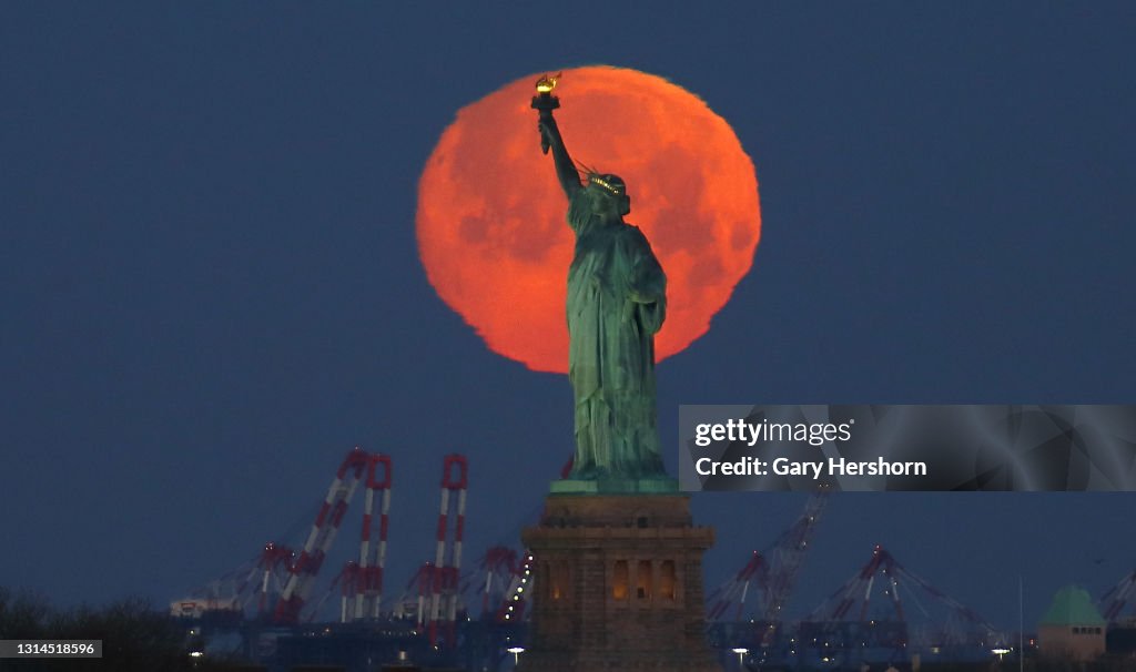Pink Moon Sets Behind the Statue of Liberty in New York City