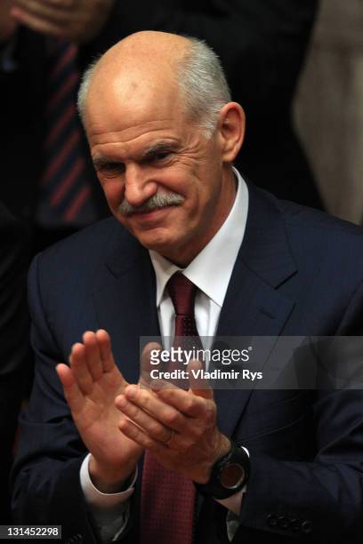 Greek Prime Minister George Papandreou applauds after winning the confidence vote for his government in the Greek parliament on November 04, 2011 in...