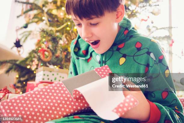 surprised boy looking at gift box during christmas - open day 11 bildbanksfoton och bilder