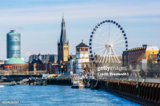 germany, dusseldorf, architecture and ferris wheel on riverbank - dusseldorf stock pictures, royalty-free photos & images