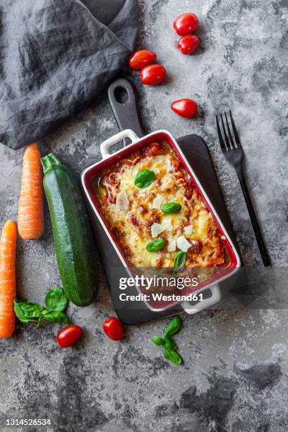 studio shot of freshly made low carb vegetarian lasagna - lasagne stock-fotos und bilder