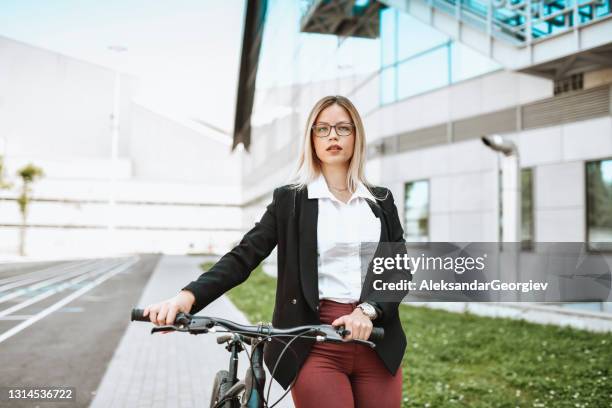 beautiful elegant female pushing bicycle to work outside - classic press conference stock pictures, royalty-free photos & images