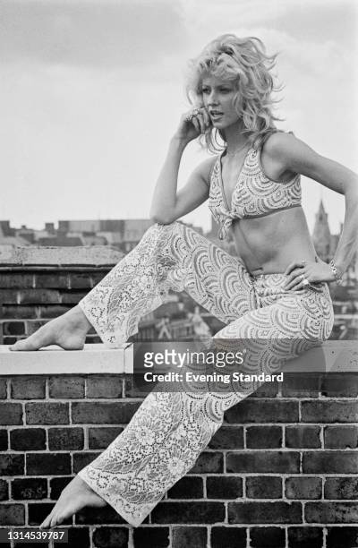 English actress and model Vicki Hodge wearing a patterned summer trouser suit with a bikini top, UK, 4th September 1973.
