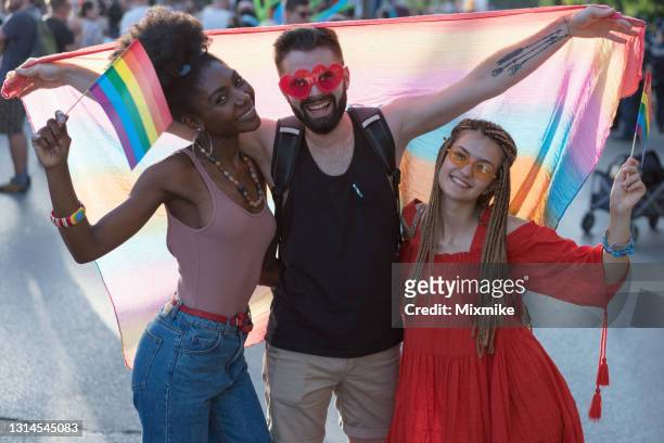 young happy people meeting at the pride festival - stereotypical stock pictures, royalty-free photos & images