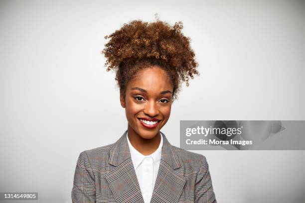 portrait of smiling african american female businesswoman on white background - black woman stock pictures, royalty-free photos & images