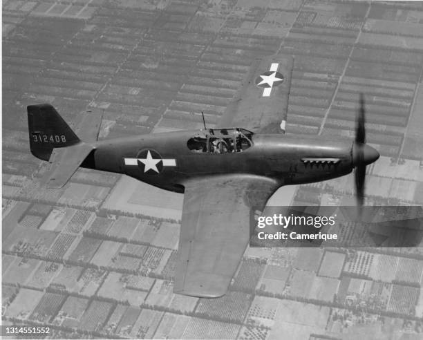 Mustang flying over land. World's outstanding fighter plane. Circa 1945