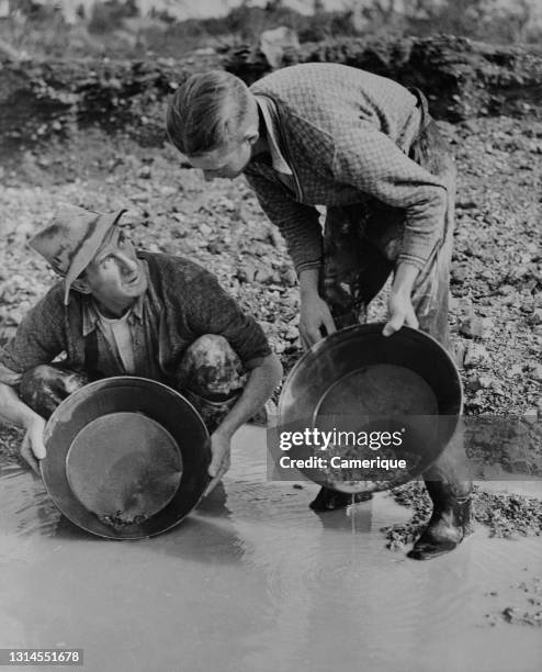 Two men dishing the dirt in search for gold at Bendigo, Victoria, Australia. Circa 1930