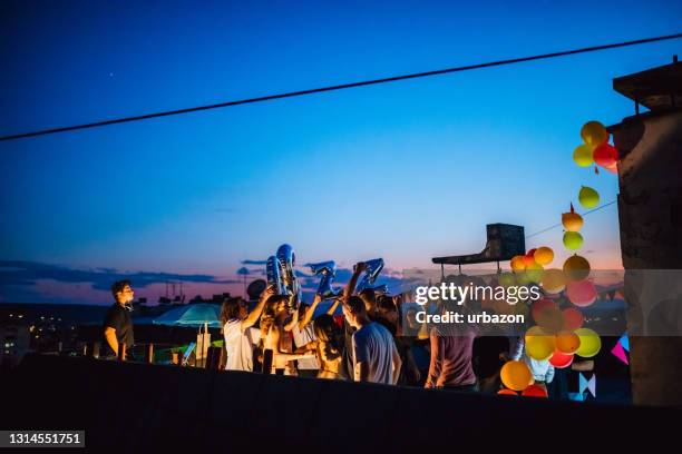 party on rooftop - summer soiree stock pictures, royalty-free photos & images